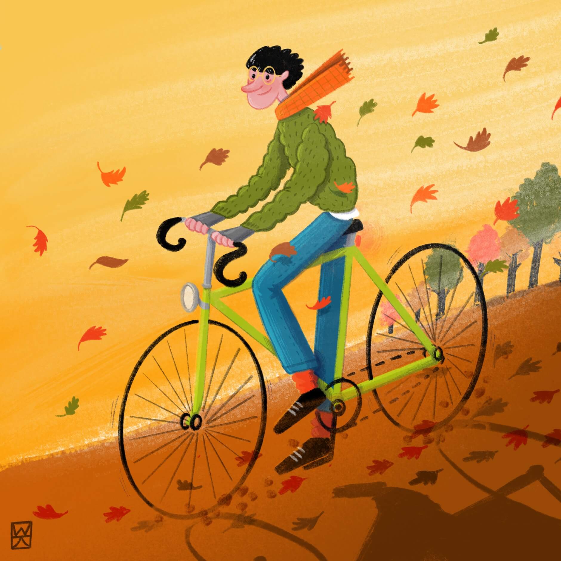 Boy rides a bicycle through colored leaves